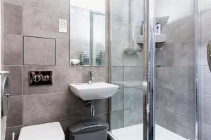 a bathroom with a sink and a toilet and a shower at Alexander Fleming House, London in London