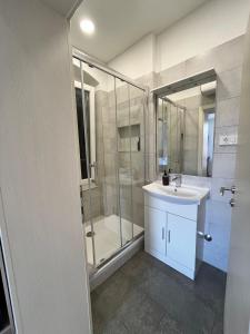 a bathroom with a sink and a glass shower at Soukki Town Centre Suites 1 in Split +12 photos