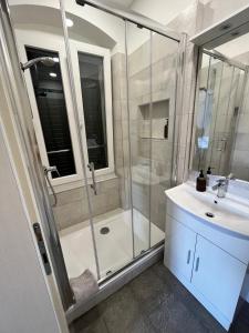 a bathroom with a shower and a sink at Soukki Town Centre Suites 1 in Split