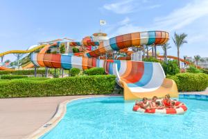 a group of people riding on a water slide at a water park at JAZ Makadi Saraya Resort in Hurghada