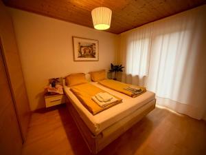 a bedroom with a bed with yellow sheets and a window at MarlingoStar in Marlengo
