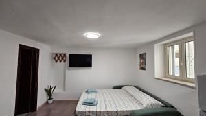 a bedroom with a bed and a tv in it at Borgo di mare in Gaeta +28 photos