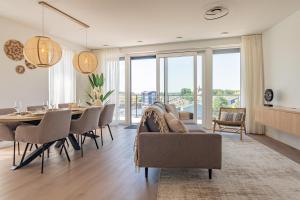a dining room and living room with a table and chairs at Appartement Havenzicht 13A Kortgene in Kortgene +41 photos