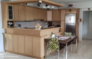 a kitchen with a table and a refrigerator at Delux 3 Bedroom Apartment Exceptional Location in Sparti