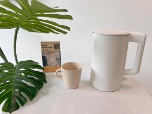 two coffee cups and a plant on a table at Vinhomes Grand Park Homestay-The Beverly Hills in Long Bình +42 photos