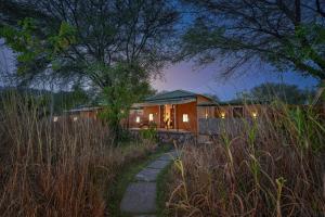 a house in the middle of a field at Alaya Stays Bagh Serai, Ranthambore in Mokholī
