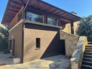 a house with a balcony on the side of it at Luxury Villa in Cluj-Napoca