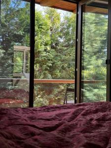 a bedroom with a bed and a large window at Luxury Villa in Cluj-Napoca
