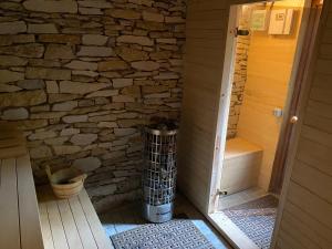 a room with a stone wall and a trash can at Luxury Villa in Cluj-Napoca +15 photos