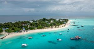an aerial view of a beach with boats in the water at Manta Ray in Fulidhoo