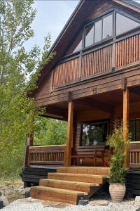 a large wooden house with a porch and stairs at Chalet Holmen in Uddevalla