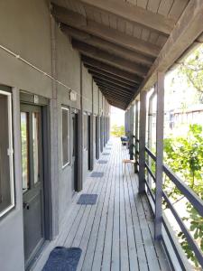 an empty porch of a building with a wooden deck at Arest Vama Veche in Vama Veche +18 photos