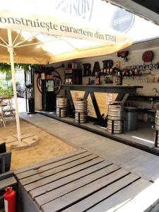 a coffee shop with a bench in front of it at Arest Vama Veche in Vama Veche