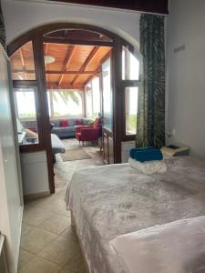 a bedroom with a bed and a living room at BLUE PANORAMA DIAMOND with Amazing Sea View in Makri