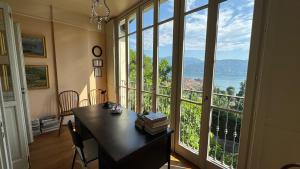 a room with a table and a large window at Villa Maria in Baveno