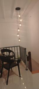 a black chair sitting in a room with a staircase at Kandy Nivahana Heights Homestay in Kandy