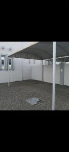 a large empty room with a building with a roof at فيلا في صحم in Murtafa‘āt Şaḩam +2 photos