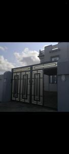 a building with a gate in front of it at فيلا في صحم in Murtafa‘āt Şaḩam