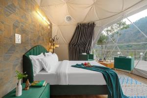a bedroom with a bed in a tent at SaffronStays Aquadome Celeste -River Access Stay in Bhikia Sain
