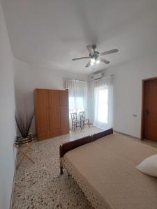 a bedroom with a bed and a ceiling fan at Terrazza sul mare in Scicli