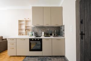 a kitchen with white cabinets and an oven at Widok Warsaw City Apartment by BookingHost in Warsaw