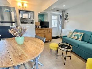 a living room with a table and a couch at Petite vague - maison atypique avec terrasse in Saint-Aubin-sur-Mer +20 photos