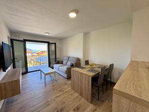 a living room with a couch and a table at Cíes Suitel Prado in Nigrán