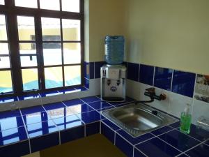 a kitchen with a sink and a blender at FRIDULI SHILOH Resort in Diani Beach +33 photos