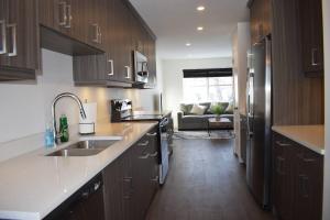 a kitchen with a sink and a counter top at Entire New Built - Spacious 3-bedroom Suite. in Regina