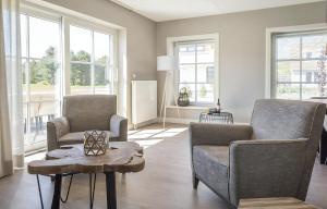 a living room with two chairs and a table at G-21 Bouwlust in De Cocksdorp