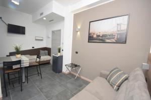 a living room with a couch and a dining room at New Comfort Apartment Igea Marina in Bellaria-Igea Marina