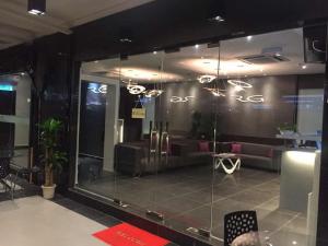 a lobby with a couch and a glass wall at The Regency Garden Hotel in Ipoh