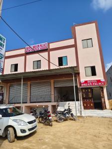 a car parked in front of a building with motorcycles at Hotel Dream Place in Pāl