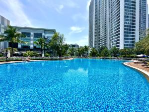 a large blue swimming pool with tall buildings in the background at High Quality Studio In Vinhomes Green Bay Near My Dinh And Keangnam in Hanoi