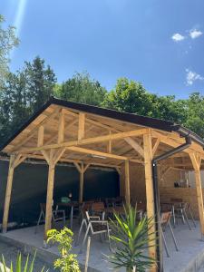 a wooden pavilion with tables and chairs in it at Casa Steluta de Mare in 2 Mai