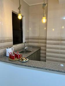 a kitchen counter with a sink and two mugs on a plate at The guset house in Kerak +57 photos
