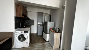 a kitchen with a washing machine and a refrigerator at Двуспален апартамент Георги Кондолов in Ahtopol