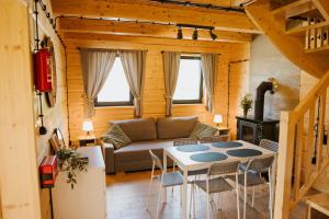 a living room with a couch and a table at PUŹNIAKÓWKA in Czarna