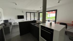 a kitchen and living room with a couch and a table at LAKE Loft Flow in Überlingen