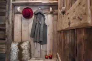 a wooden wall with a coat hanging on it at Villa Kofler Wonderland Resort in Campitello di Fassa +18 photos
