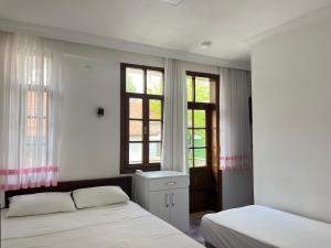 Postel nebo postele na pokoji v ubytování Kaptan Pansiyon