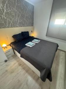 a bedroom with a bed with two towels on it at Apartamento Justina in Cullera