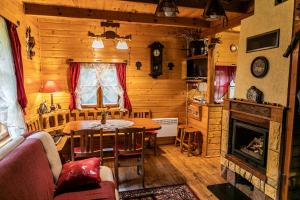 a living room with a table and a fireplace at Sielski Zakątek in Piecki