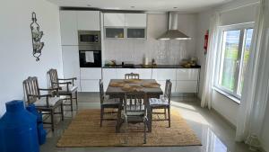 a kitchen with a table and chairs in a room at Casas Fonte da Tapada - Casa da Mina in Trancoso