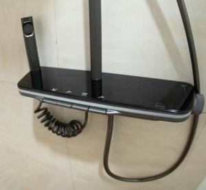 a cell phone is hanging on a wall at A-Frame tiny house in Arusha