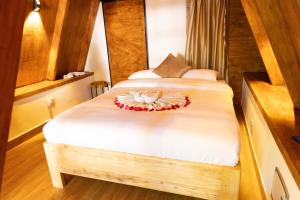 a bedroom with two beds with white sheets at A-Frame tiny house in Arusha