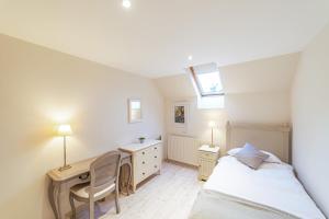 a bedroom with a desk and a bed and a desk at Penninghame Estate - Wallace Apartment in Challoch