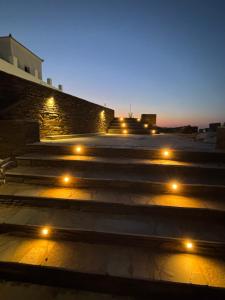 a group of stairs with lights at night at Cavo Levante in Andros