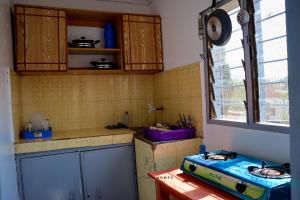 a kitchen with a blue stove and a window at Kristina Homes 1&2 Bedroom Apartment in Voi