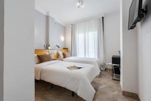 Posteľ alebo postele v izbe v ubytovaní Hotel Agur
